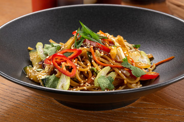 Stir fry with soba noodles, vegetables. Asian healthy food, stir fried meal in bowls. Spicy noodles. Vegetarian Noodles or Vegetable Hakka Noodles or Chow Mein. Indo-chinese cuisine hot dish
