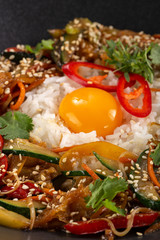Thai food fried rice with egg. Asian cuisine-Homemade egg fried rice served with vegetables. Fried rice with vegetables, pepper, carrot, cucumber, parsley, onion, eggs, chilli. Indo-chinese cuisine