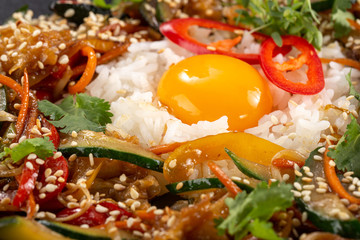 Thai food fried rice with egg. Asian cuisine-Homemade egg fried rice served with vegetables. Fried rice with vegetables, pepper, carrot, cucumber, parsley, onion, eggs, chilli. Indo-chinese cuisine