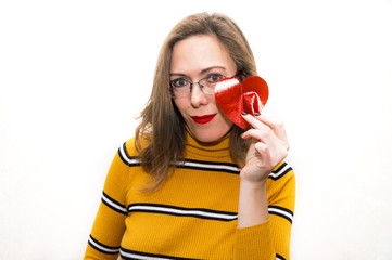 Smiling woman in glasses in yellow clothes with a heart red lipstick Valentine's Day on a white background