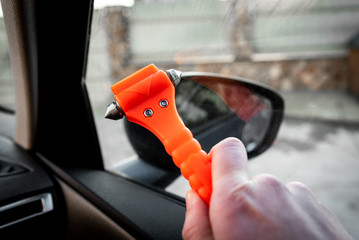 Safety hammer mounting and seatbelt cutter in car use in case accident. 