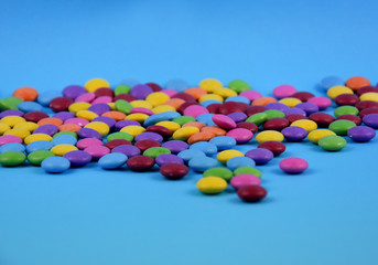 Colorful candies on a blue background stock images. Sweets isolated on a blue background. Candy on a blue background with copy space for text