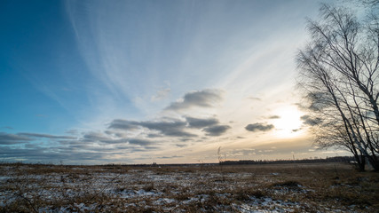 Beautiful setting sun over frozen field