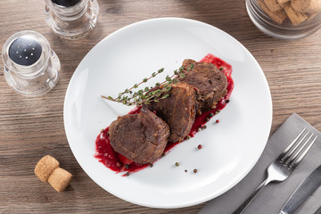 Juicy medium rare fillet steak mignon. Closeup view of delicious grilled beef medallions served on...