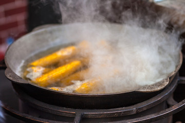 Street food. Boiling corn.