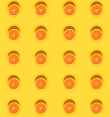 Colorful fruit pattern of fresh orange slices on yellow background