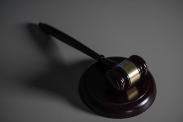 Law and Justice concept. Mallet of the judge, books, scales of justice. Dark Courtroom theme.