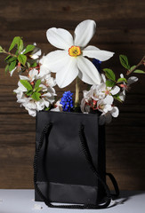 bouquet of spring flowers in a paper bag