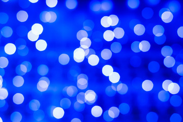 Defocused abstract blue bokeh lights background. Holidays concept.