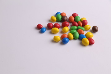 Fototapeta na wymiar delicious colorful chocolate balls stuffed with peanut