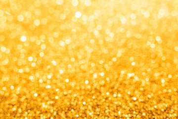 Złoty bokeh powiększający się z dołu do góry. Piękne rozmyte tło w ciepłych złotych odcieniach.