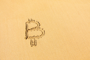 Image of icon bitcoin cryptocurrency on golden sand with sea water background. Concept freelance, stock exchange BTC sign hand written at sandy beach. Unstable rise and fall of concept, top view
