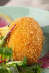 Chicken Kiev cutlets with parsley leaves. Ukrainian tradition food. Chicken Kiev, ukrainian cuisine. Chicken cutlet in bread crumbs stuffed with butter and herbs, served with mashed potato. Close up