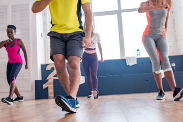 Fototapeta premium Low angle view of zumba dancers training in dance studio