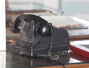Vintage black telephone displayed at a flea market