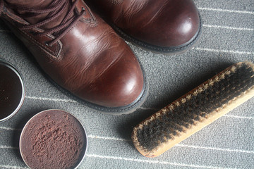 Braune Lederstiefel werden mit Schuhcreme gepflegt