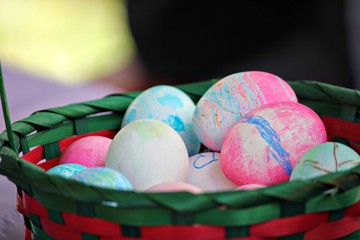 Wide shot of a basket with colorful painted Easter eggs