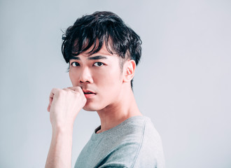  portrait of young  asian handsome man isolated on gray background