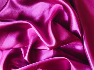 Hot pink Silk satin fabric texture background, top view.  fabric texture background. wavy canvas pattern. Fabric Tails