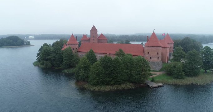 Trakai, Lithuania: medieval gothic Island castle, located in Galve lake and town in the background. Aerial above summer UAV top view, flat lay of the most beautiful Lithuanian landmark.
