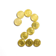 the figure of 2 laid out of bitcoin coins and isolated on white background