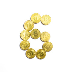 the figure of 6 laid out of bitcoin coins and isolated on white background