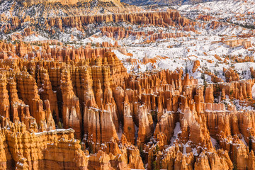 Famous orange hoodoos of Bryce Canyon National Park in winter covered with snow seen from...