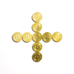 the plus symbol  laid out of bitcoin coins and isolated on white background