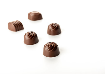 Chocolate pralines on dark background