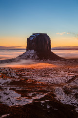 Orange sunset over the Merrick Butte at Monument Valley in winter