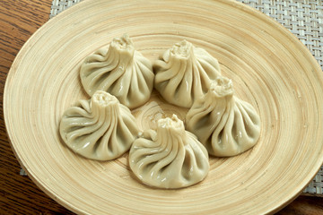 khinkali with meat on a plate on the table