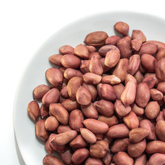 Obraz premium Peeled peanuts on a white isolated background. Food nuts delicious for your design for the site. kitchen theme