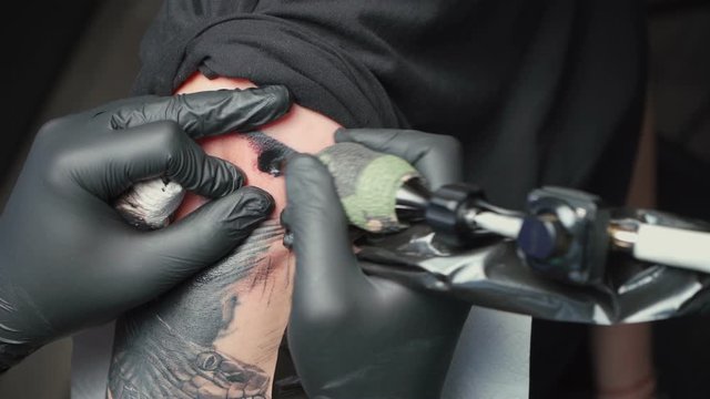 Video of young tattooist getting tattoo of snake for woman