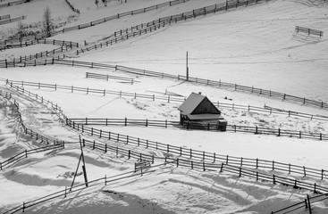 Village covered by fresh snow. Monochrome