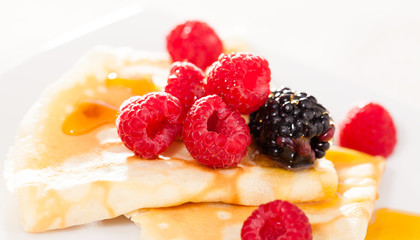 pancakes with raspberries, blackberries and honey