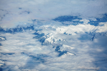 Fototapeta premium aerial view of clouds over the snowy mountains