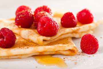 delicious  pancakes with fresh raspberries and honey