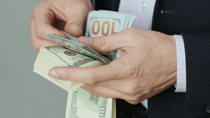 Men's hands quickly count banknotes. Businessman counts dollars in hands. USD - Powered by Adobe