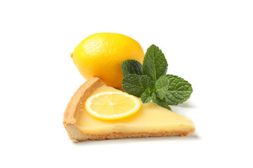 Delicious lemon tart slice, mint and whole lemon isolated on white background