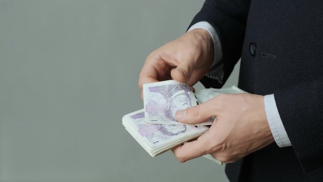 Men's hands quickly count banknotes. Businessman counts banknotes of czech krona in hands. CZK