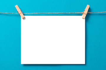 sheet of paper on rope with clothes pegs