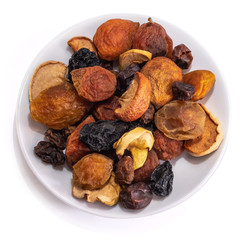 Mix of dried fruits on a white isolated background. Food grapes, apple, raisins, hazelnuts, dried apricots for your website design. kitchen theme