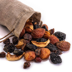 Mix of dried fruits on a white isolated background. Food grapes, apple, raisins, hazelnuts, dried apricots for your website design. kitchen theme