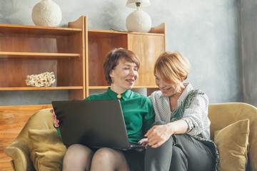 Casual mature women with laptop at home