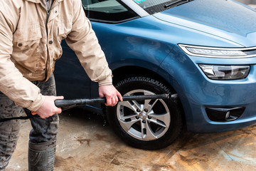 Process of car washing using high pressure water.