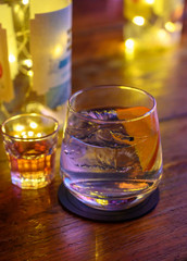 Glass of gin with tonic water, orange and ice