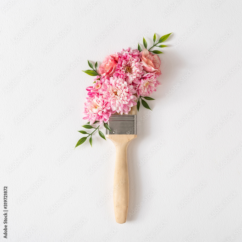 Poster flowers composition. creative layout made of pink and white flowers and paint brush on white backgro