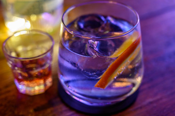 Glass of gin with tonic water, orange and ice