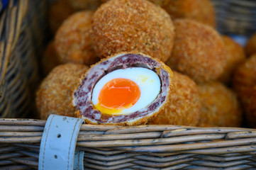 Traditional street food in UK, stuffed Scottish eggs with breadcrumbs