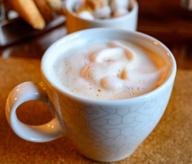 White cup with coffee with white milk foam